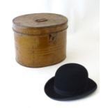 A Falcon Make bowler hat retailed by Woodman & Sons Hatters & Hosiers, Manchester House, Winslow,