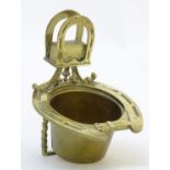 A 19thC brass smoker's companion, comprising ashtray and vesta holder with cast horse shoe and