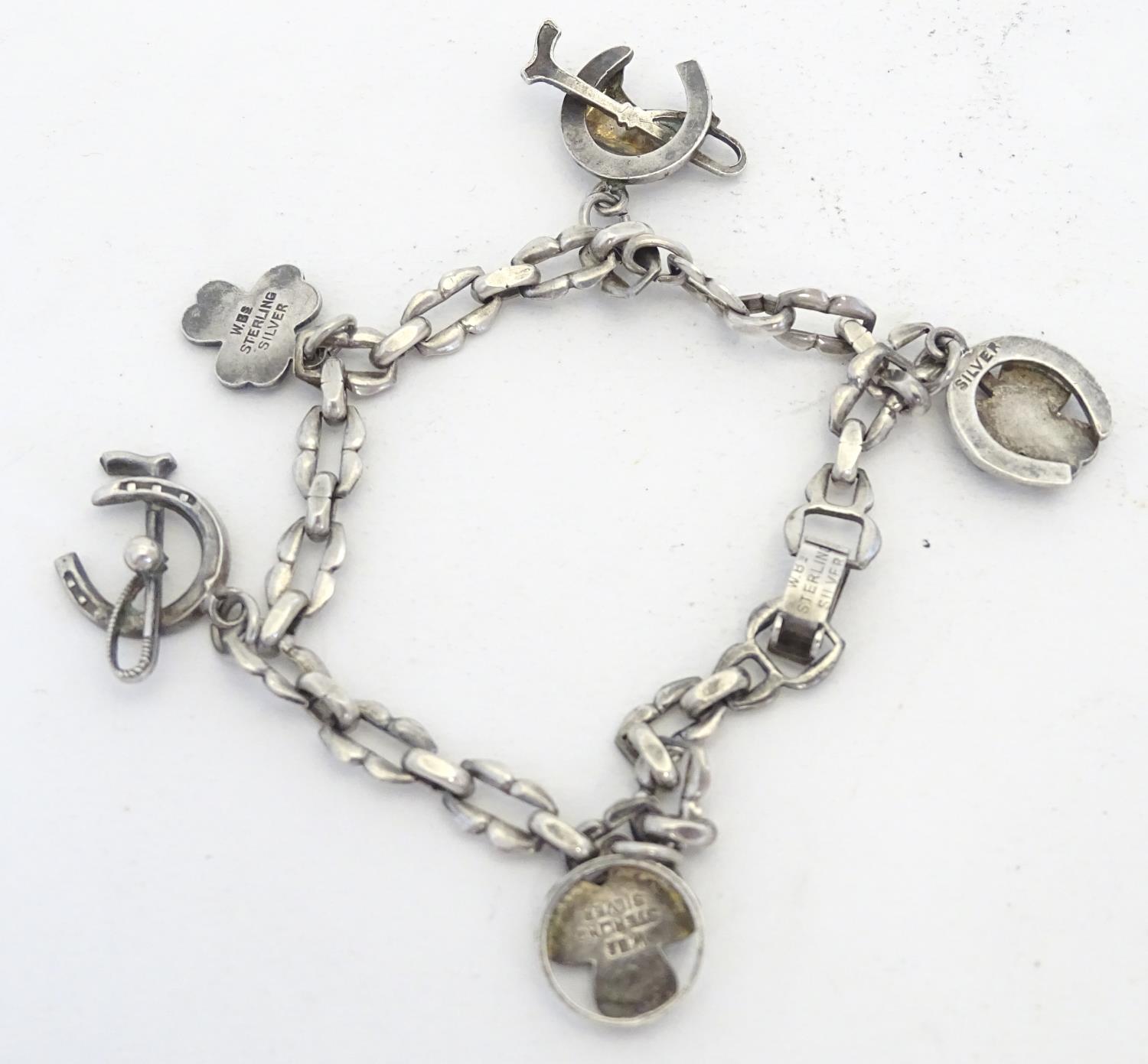 A silver charm bracelet set with various charms including horseshoe, horsehead and horseshoe and - Image 7 of 9