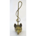 A Victorian cast brass figural doorstop/door porter, hunting themed, formed as a fox mask surmounted