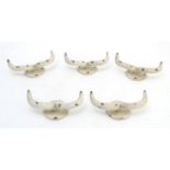 Five cast wall hanging coat hooks formed as stylised rams horns with painted decoration. Approx. 7