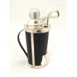 A novelty cocktail shaker formed as a golf bag with stirrers etc formed as golf clubs. 11'' high