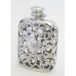 A Victorian hip flask, the glass flask with ornate silver mounts with acanthus scroll detail