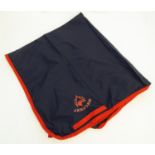 A lined waterproof horse exercise sheet in navy and red, approx. 4' Please Note - we do not make