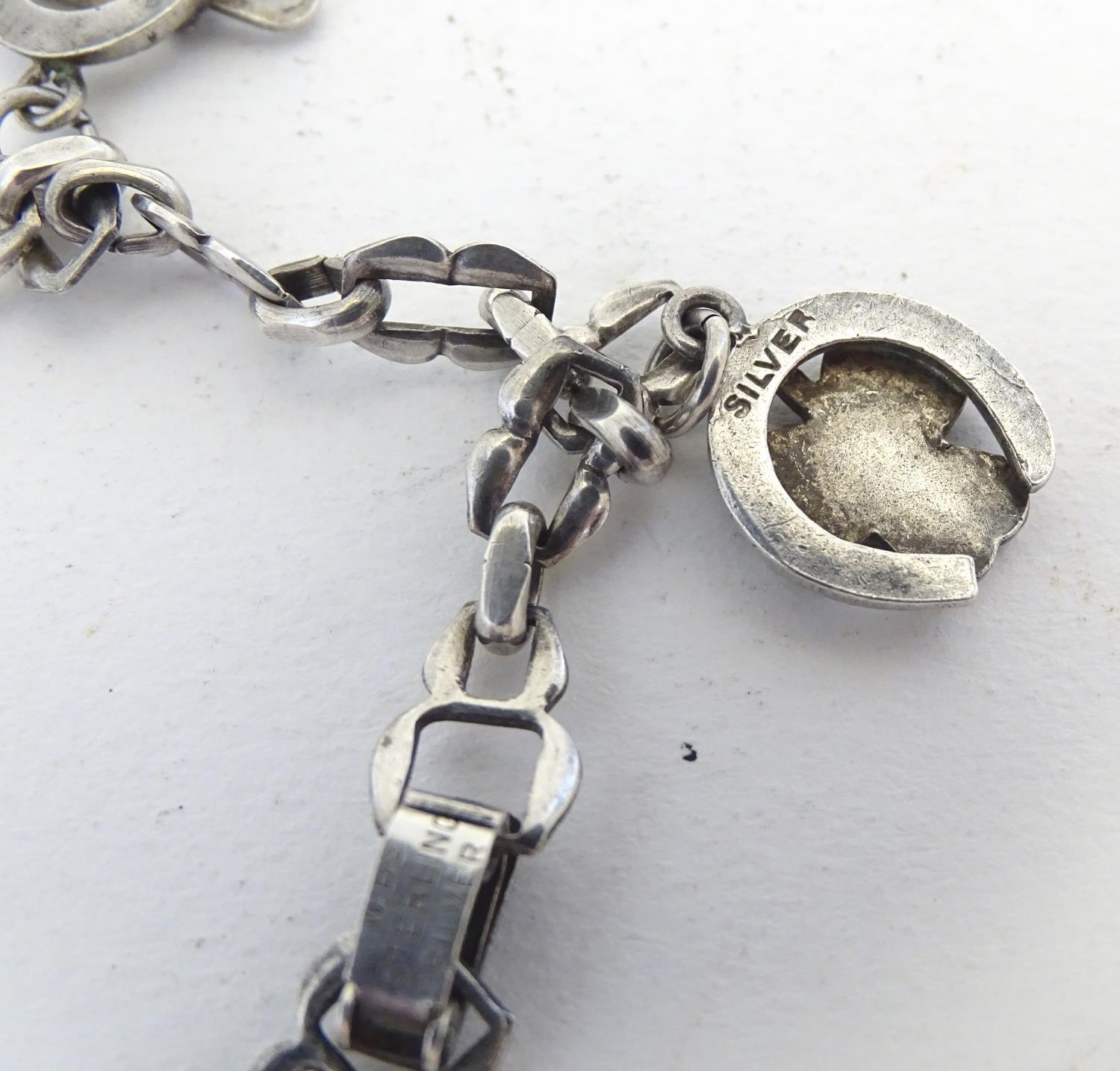 A silver charm bracelet set with various charms including horseshoe, horsehead and horseshoe and - Image 2 of 9