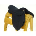 A black narrow synthetic horse riding / equestrian saddle. Approx. 17" Please Note - we do not