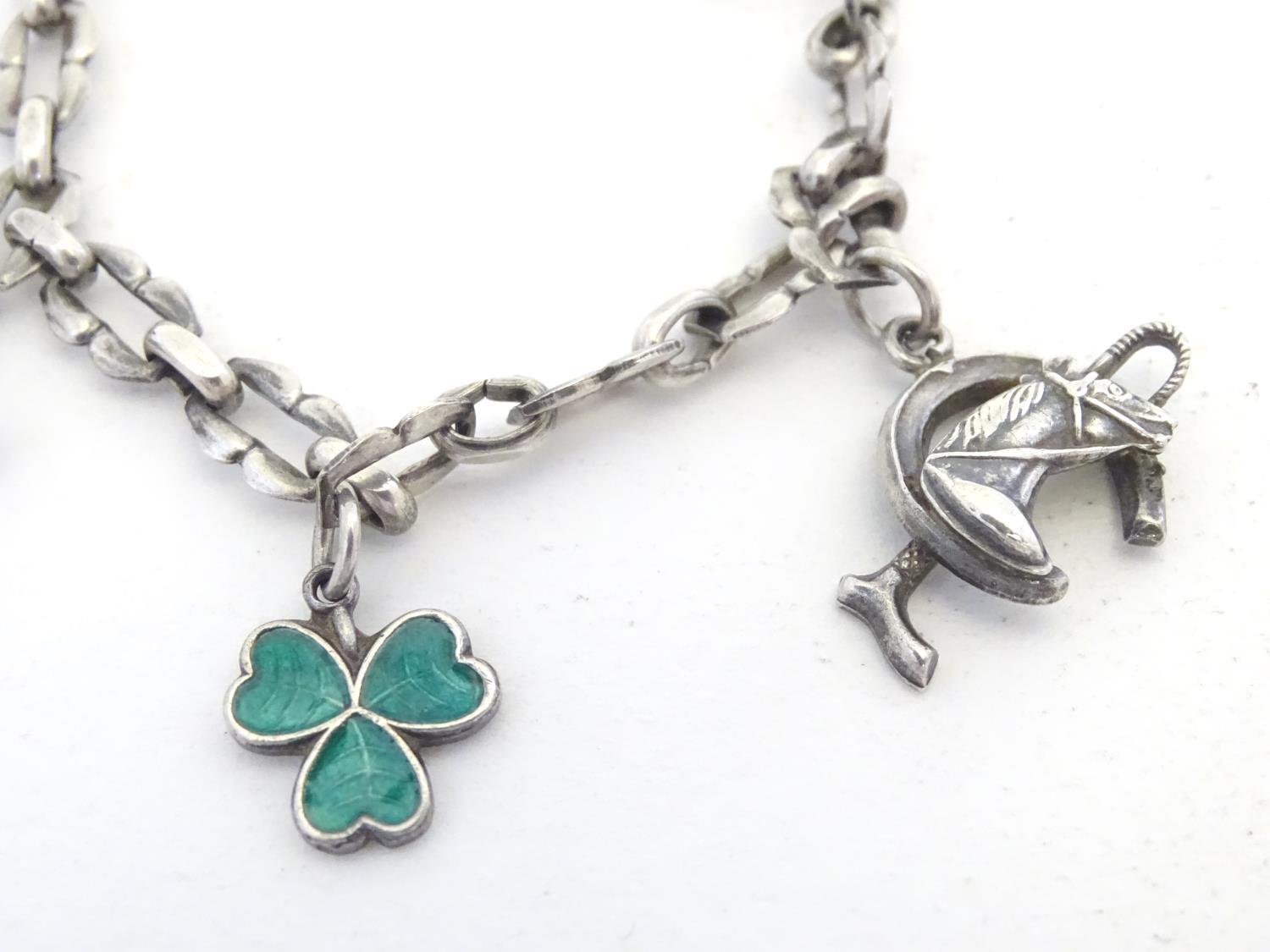 A silver charm bracelet set with various charms including horseshoe, horsehead and horseshoe and - Image 5 of 9