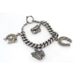 A silver charm bracelet, the heavy curblink bracelet set with various equine themed large charms /