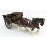 A large ceramic shire horse with harness and reins, and hand / scratch built wooden cart. Horse