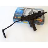 Airgun: a boxed Uzi/KWC 'Model KMB-07' .177 Co2 BB air pistol, with folding stock and 25 shot