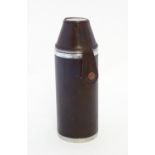 A leather covered flask with three tot cups to top. marked ' Debrett's'. Approx 6" high overall.