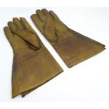 A pair of early 20thC mens leather driving gloves. Approx. 13 1/2" long Please Note - we do not make