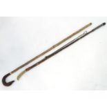 Fishing: two hazel wading sticks, one with antler thumbrest handle and lead weight, the other with