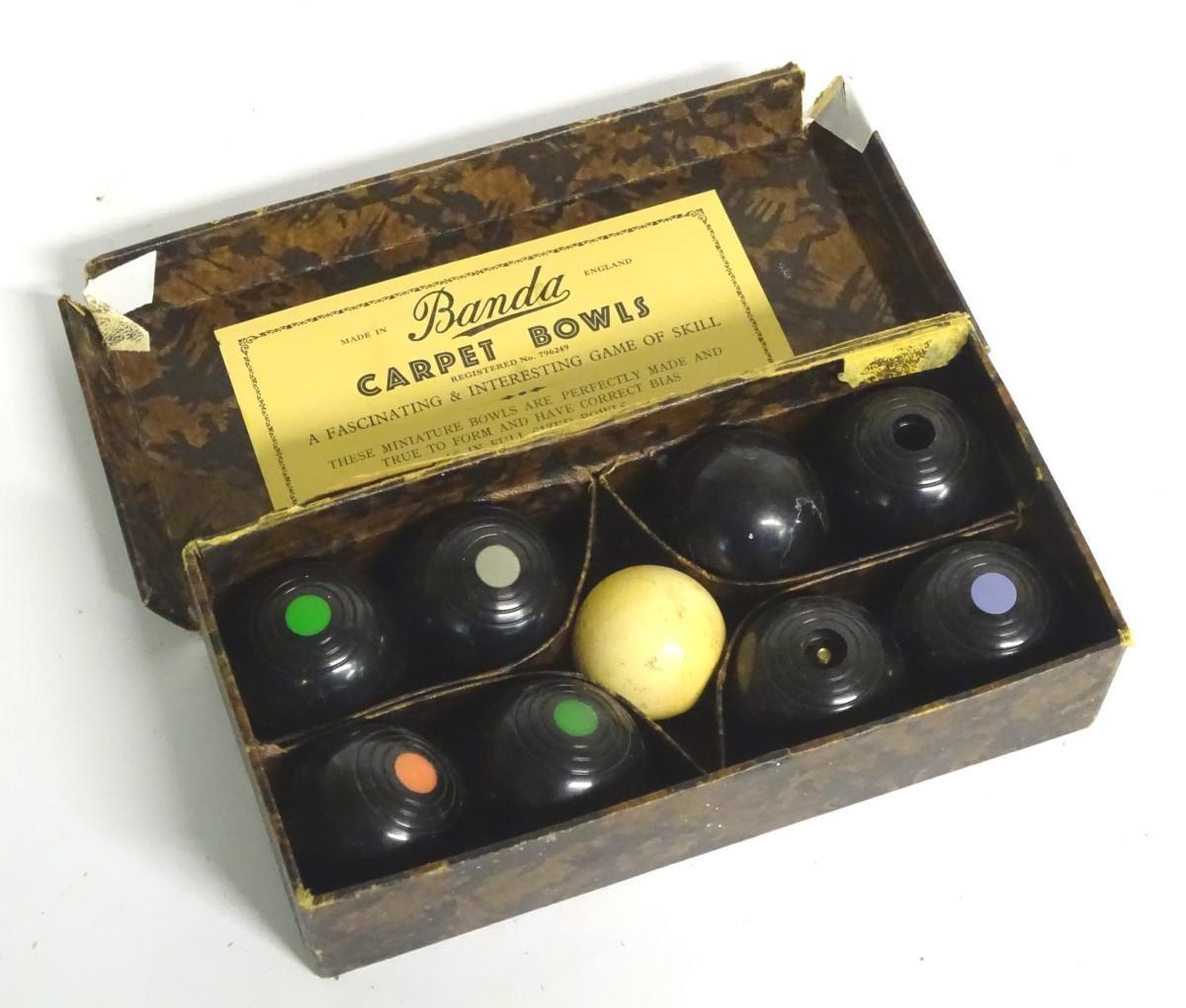 A cased set of 20thC Banda Carpet Bowls, Made in England. Please Note - we do not make reference