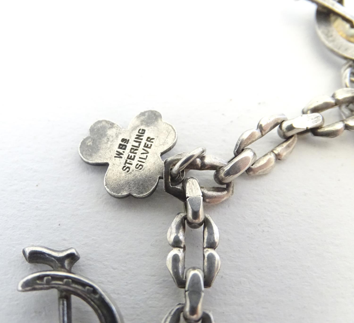 A silver charm bracelet set with various charms including horseshoe, horsehead and horseshoe and - Image 9 of 9