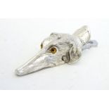 A novelty silver plate desk top letter clip of dog head form. 21stC 6" long Please Note - we do