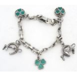 A silver charm bracelet set with various charms including horseshoe, horsehead and horseshoe and