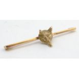 A 9ct gold brooch with fox head decoration. 2" wide Please Note - we do not make reference to the