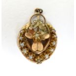 A 19thC gold and gilt metal pendant of horse shoe form with seed pearl detail. 3 /4" long Please