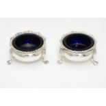 A pair of Victorian silver table salts with blue glass liners. Hallmarked London 1892 maker