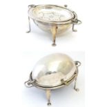 A silver plate serving dish on four feed with domed cover and grill within. Approx 14" wide Please