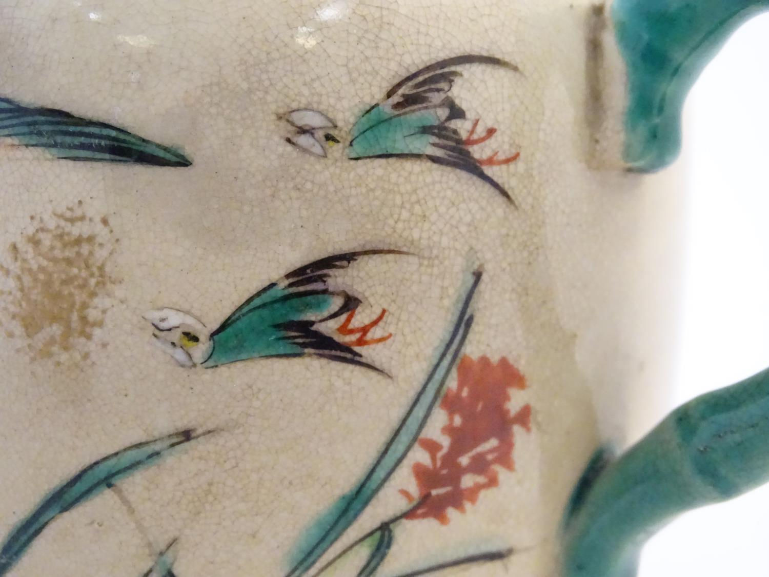 A Japanese teapot and milk jug with hand painted decoration depicting birds and flowers, the handles - Image 2 of 9