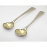 A pair of silver salt spoons with gilded bowls. hallmarked London 1827 maker RC. 4" long Please Note