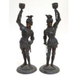 A pair of early 20thC candlesticks formed as French armoured knights, each measuring 15" tall Please