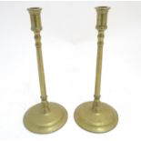 A pair of 19thC brass candlesticks, the narrow columns supporting turned cups and standing on wide