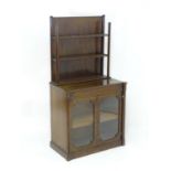 A 19thC mahogany Gothic glazed bookcase, writing desk with a three tier bookcase flanked by