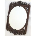 A 19thC rosewood mirror with a carved anthemion and foliate top, having pierced fretwork brackets to