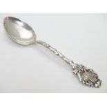 A Canadian Sterling Silver Souvenir Spoon, the handle of branch form titled Canada, decorated with