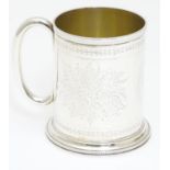 A Victorian silver mug with engraved decoration and loop handle. Hallmarked London 1872 maker