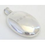 A Victorian silver hip flask of ovoid form engraved RRBM. Hallmarked London 1867, maker HJ Lias