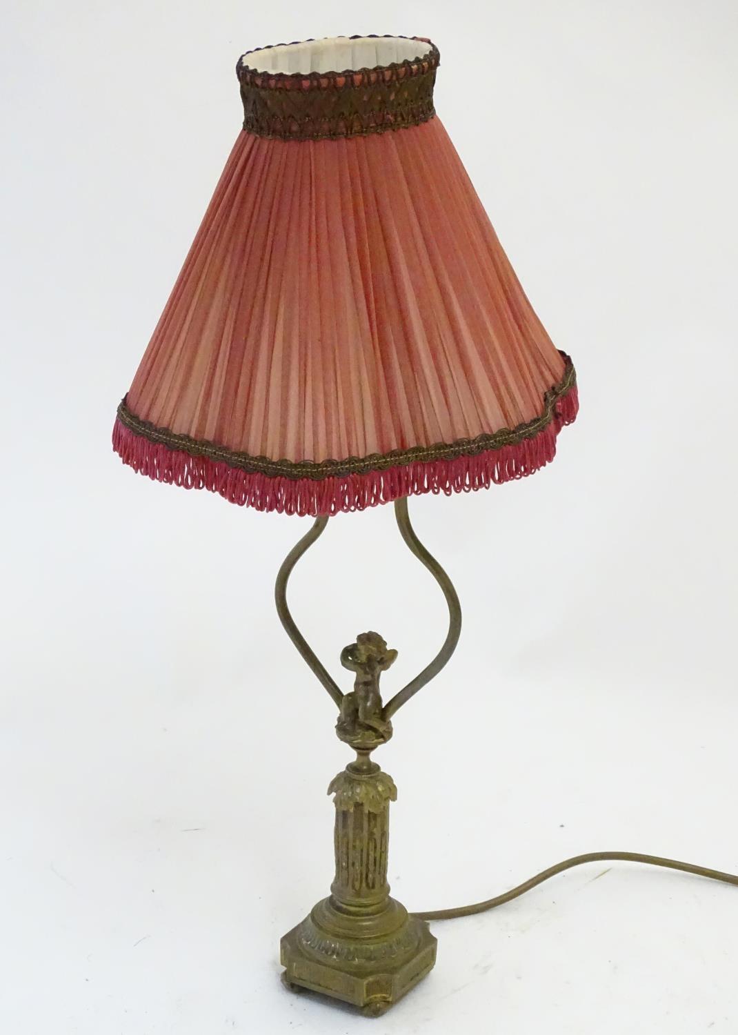 A mid to late 20thC brass table lamp, formed as a Corinthian column surmounted by a putto. 22" - Image 3 of 6