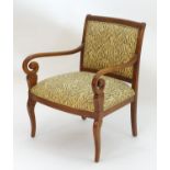 A late 20thC open armchair with upholstered back rest and seat, scrolled arms and raised on cabriole
