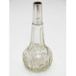 An early 20thC cut glass scent bottle with silver collar. 6 1/4" high Please Note - we do not make