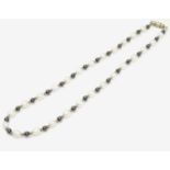 A necklace of pearl and iolite beads. Approx. 16" long Please Note - we do not make reference to the