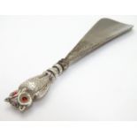 A shoe horn the silver handle formed as an owl. hallmarked Birmingham 1907 maker Crisford &