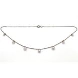 A silver necklace set with graduated pearl drops. Approx 16" long Please Note - we do not make