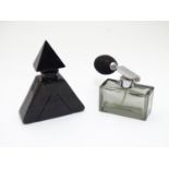 Two Art Deco glass scent bottles, one black glass formed as a pyramid, the other smoked glass with