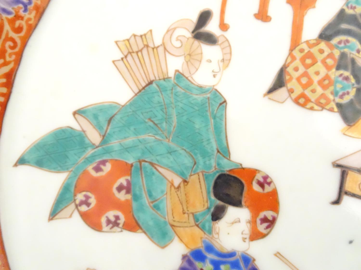 A Japanese twin handled plate with hand painted decoration depicting six seated figures with - Image 8 of 8