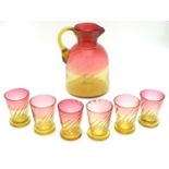 A 19thC amberina glass aperitif set, each decorated with optic swirl patterns, the pitcher 7"