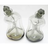 Two 20thC Danish smoked glass decanters with pinch detail by Holmegaard, each approximately 9"