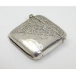 A silver vesta case with engraved decoration and hinged lid hallmarked Chester 1908 maker Smith &