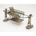 A silver plate model of an Oriental rickshaw, possibly a table coaster. Approx 8 1/2" long Please