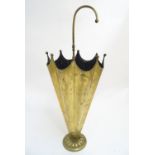 An early 20thC brass stick stand formed as an upturned umbrella, with internal division and weighted