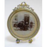 A Victorian monochrome photographic group portrait depicting a young couple, an older lady and two