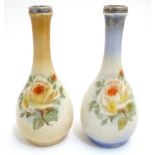 A matched pair of English bottle vases with floral rose decoration with silver rim, hallmarked
