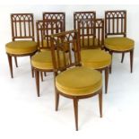 A set of eight 19thC French dining chairs with squared backs and lancet tracing, the corners of